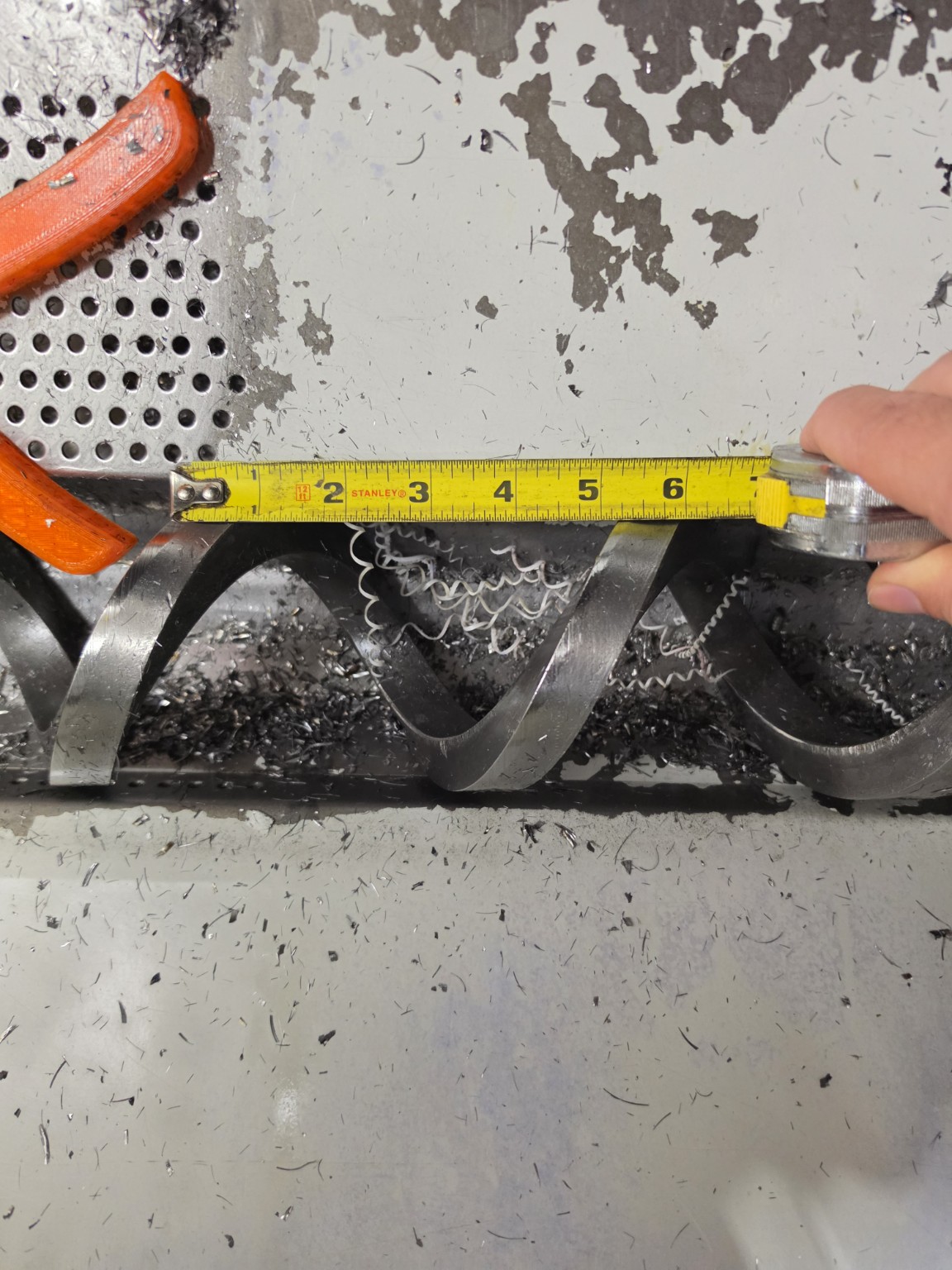 Tape measure showing the distance between corresponding points on adjacent auger flights