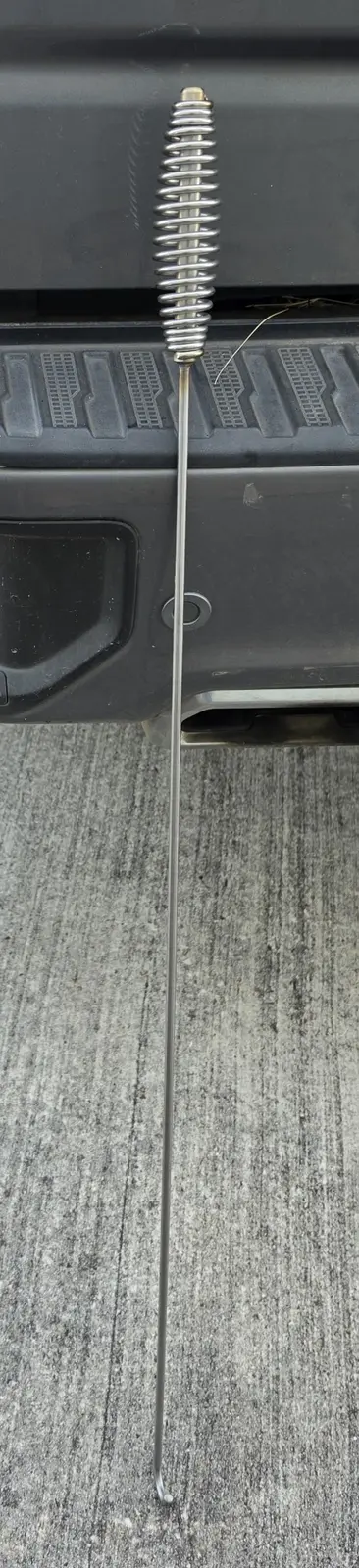 Full 39-inch stainless-steel Go-Fer Stick hanging from a pickup tailgate