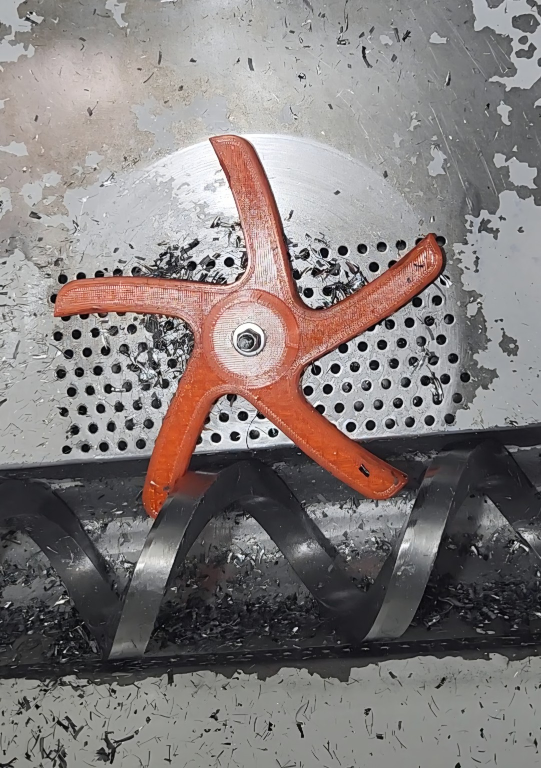 Orange Chip Screen Spider installed above a Haas chip auger