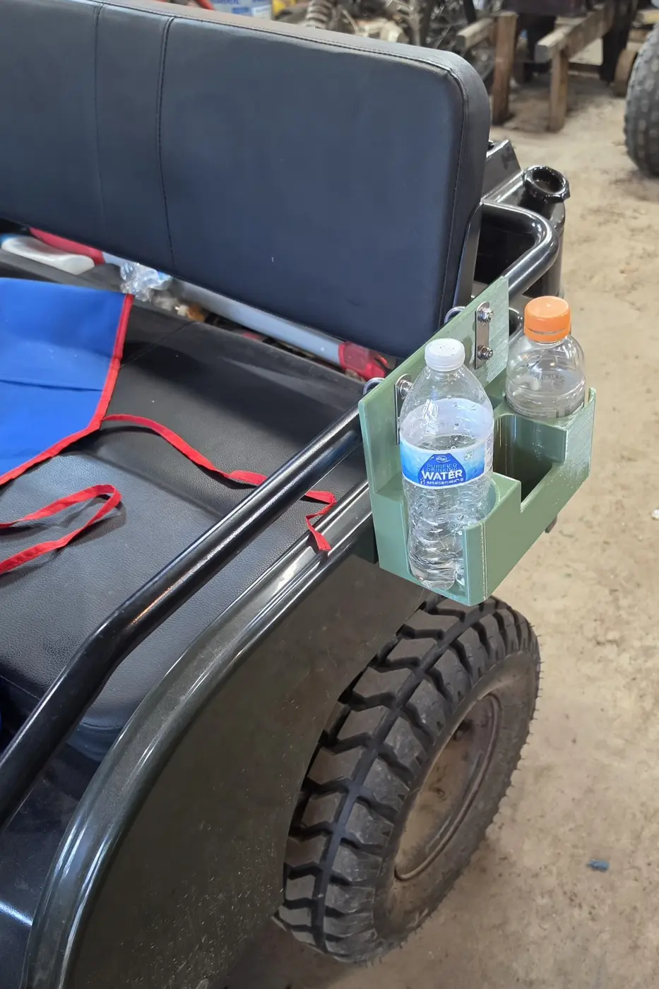 Green mini Jeep cup holder and storage organizer mounted beside the seat with two drinks