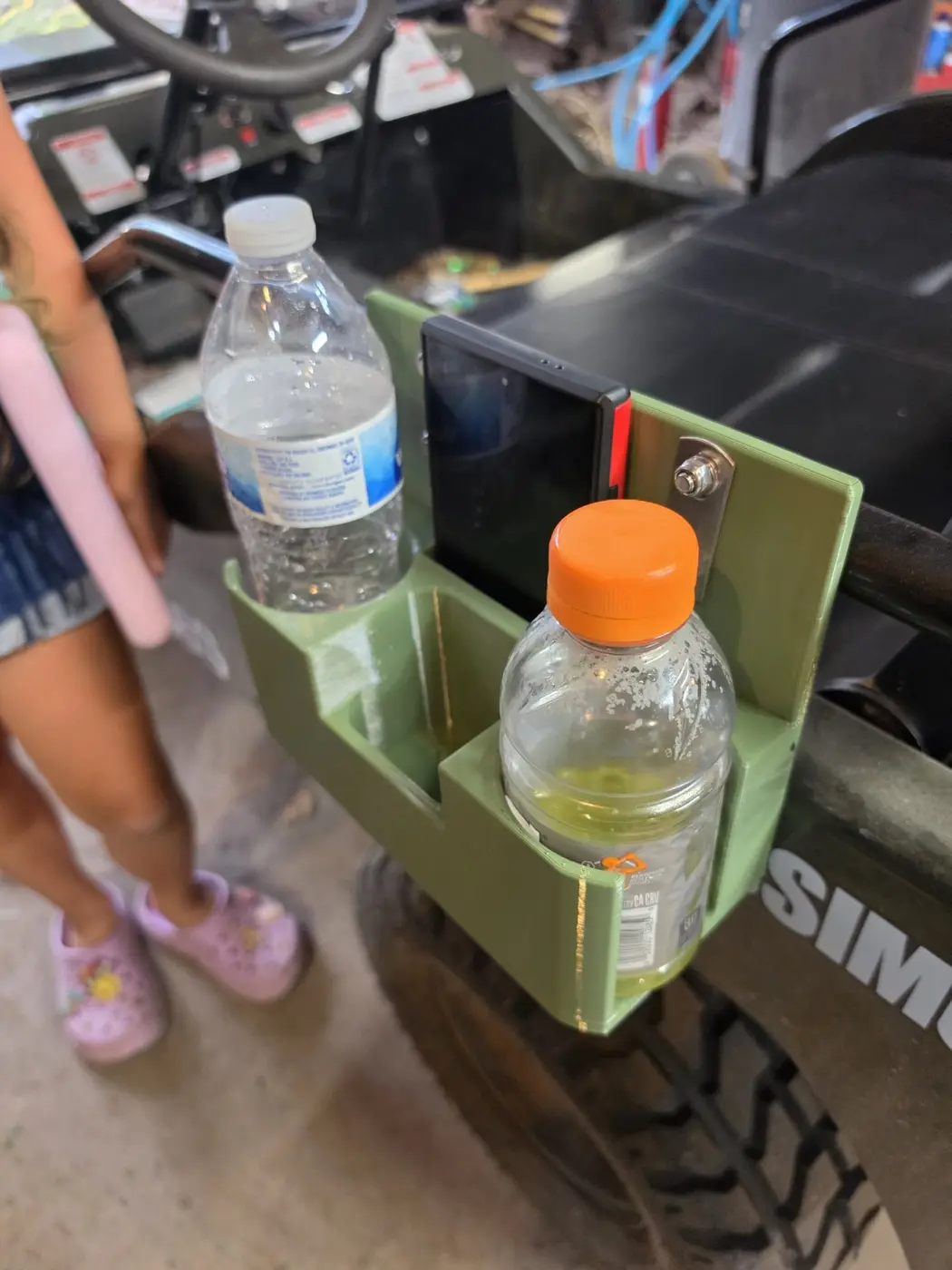 Angled view of the mini Jeep organizer holding two bottles and a phone